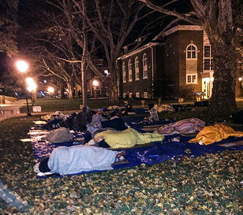 Rows of students sleeping on tarps and cardboard at Moravian College Sleep Out