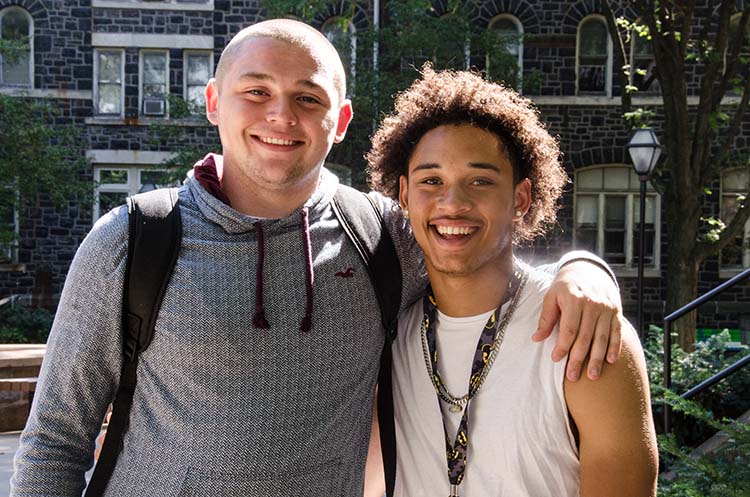 Two male Moravian students outside Comenius Hall