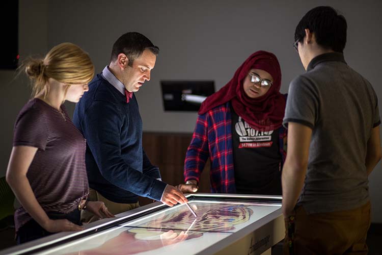 Students around the virtual cadaver lab learn anatomy