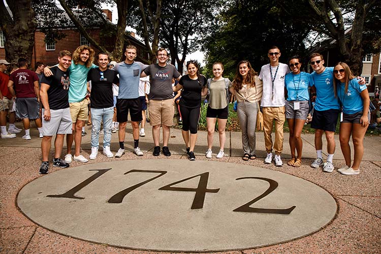 Students stand arm-in-arm around the 1742 splotch.