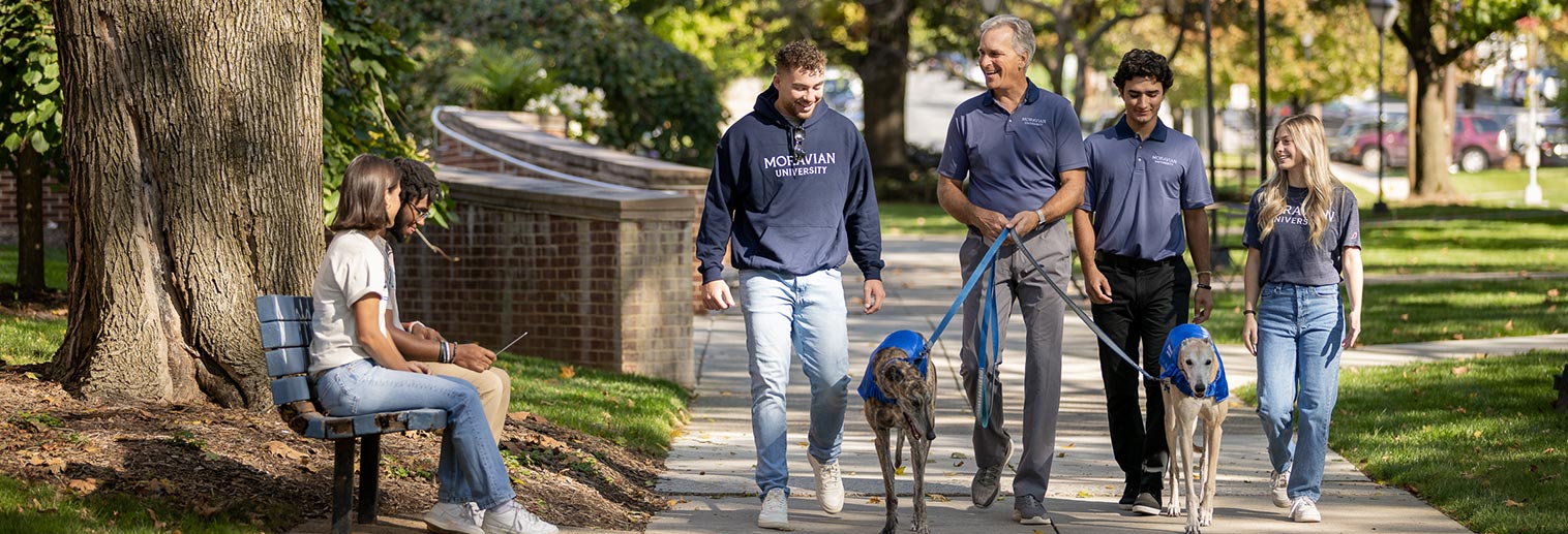 Grigsby walking with students