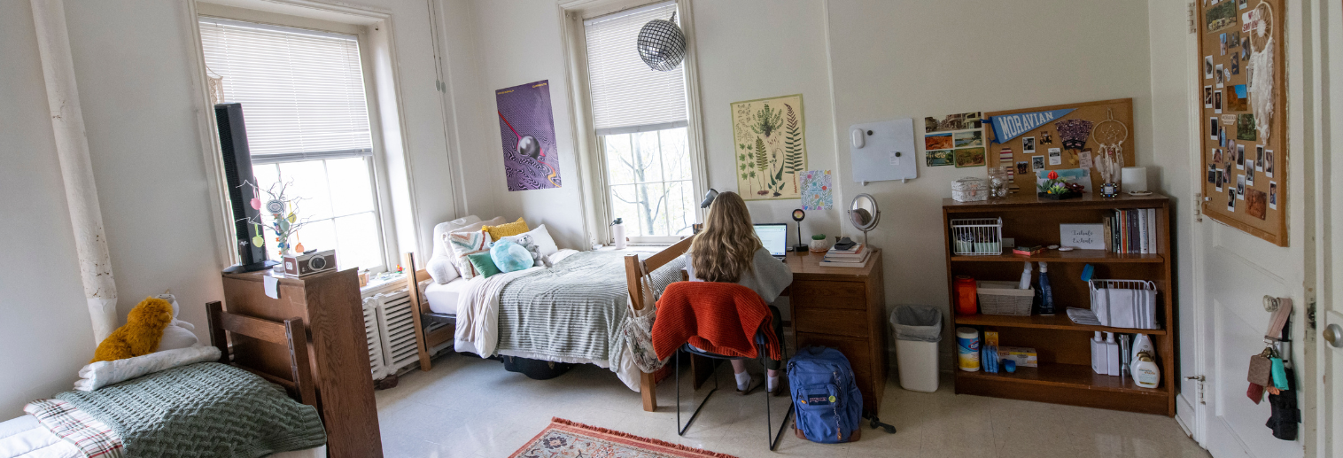 Photo of student sitting in residence hall room