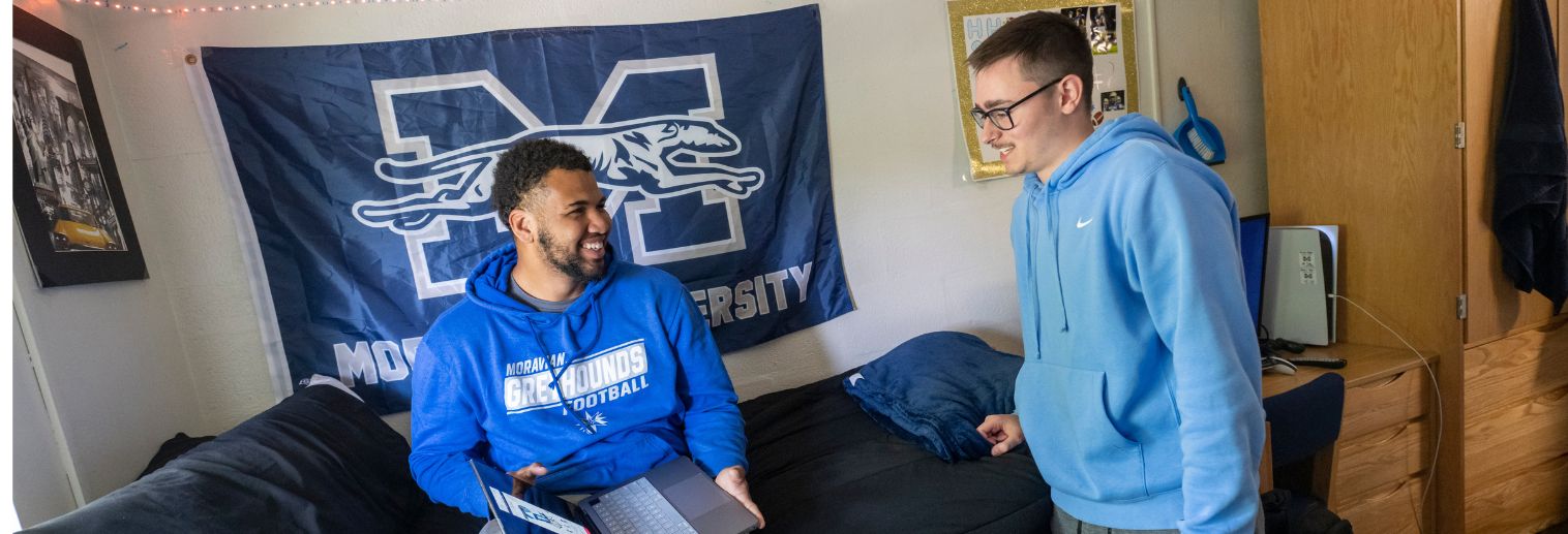 Photo of two students in first-year residence hall room