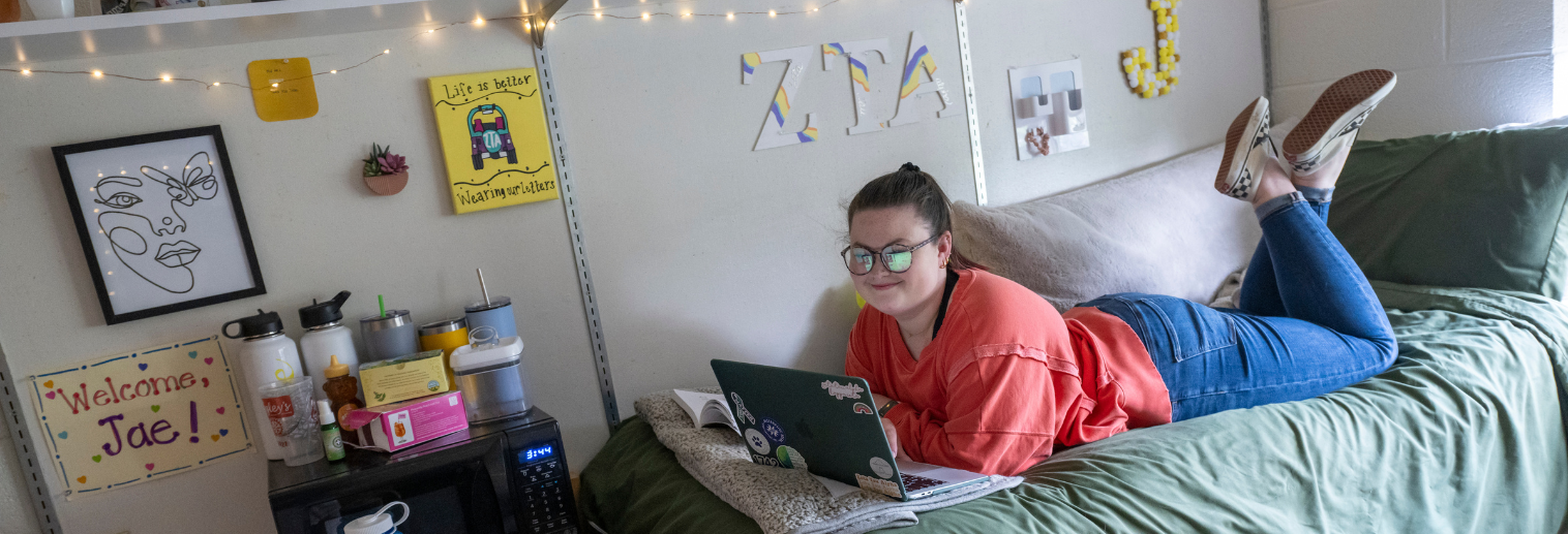 Photo of student in upperclass residence hall room