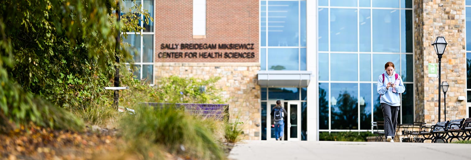 Student walking outside the Sally