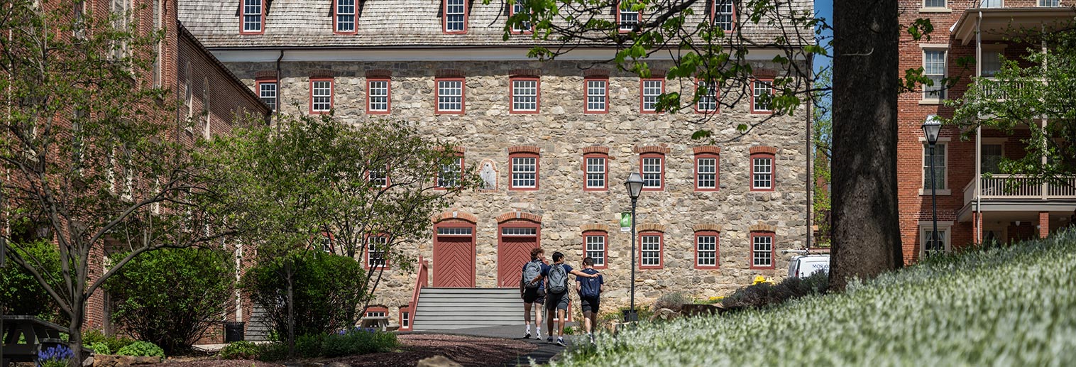 Students walking behind Bretherns House