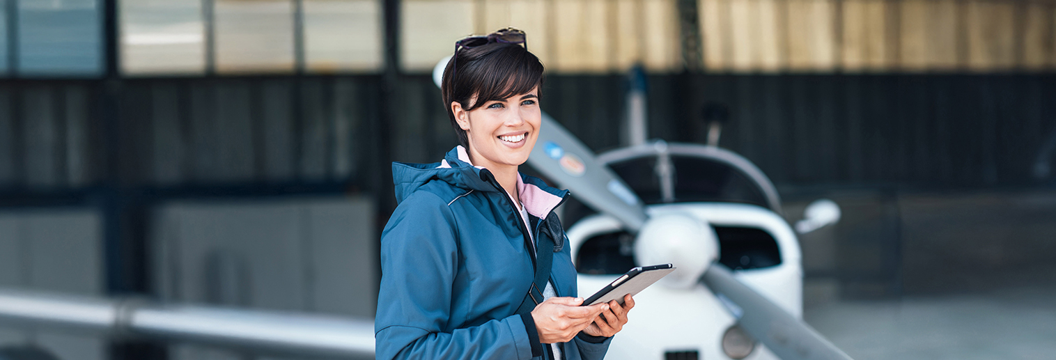 Woman standing in airplane hanger