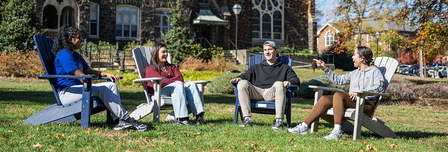 Student sitting outside Comenius