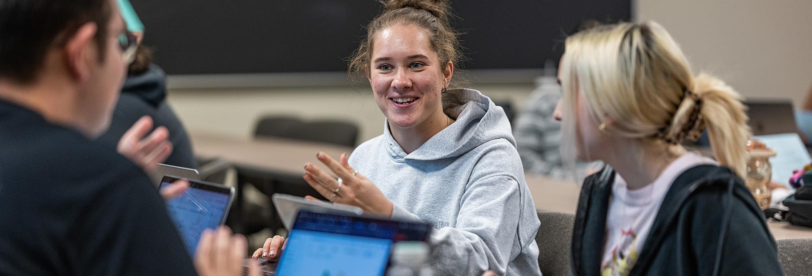 Student in class using laptops