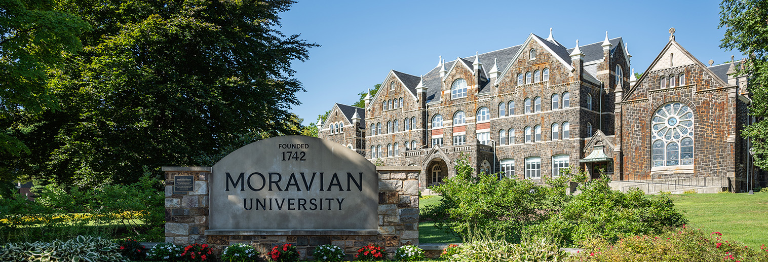 Comenius Hall with Moravian sign in summer