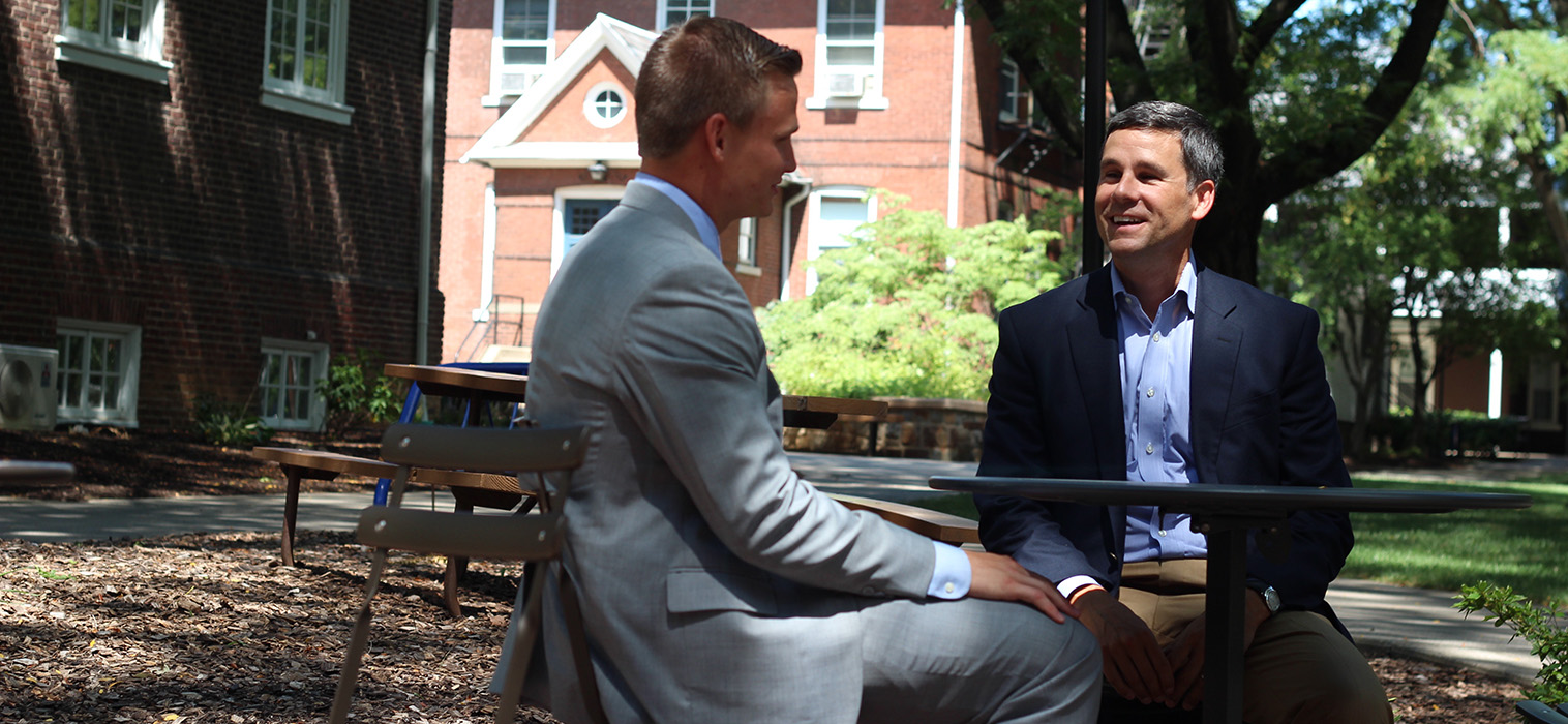 Andy Hart '90 and Jonathan Strauss '16 speak on Moravian University's historic campus