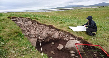 Chelsea Kaufman working on a technical drawing of a trench on the island of Orasaigh, South Uist in the Outer Hebrides of Scotland
