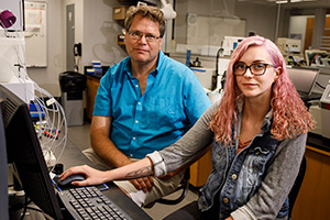 Lauren works at a computer with her faculty mentor.