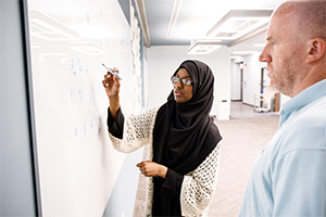 Makkah writes on a whiteboard.