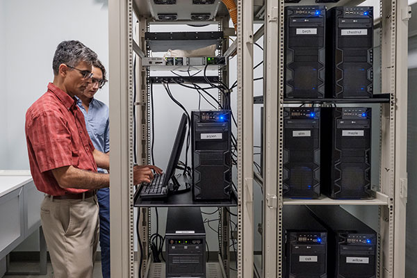 Student works with professor in computer lab