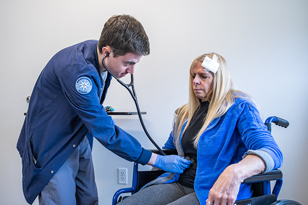 Moravian University students working with a standardized patient in the simulation lab.