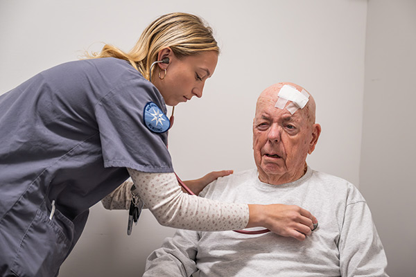 Moravian University students working with a standardized patient in the simulation lab
