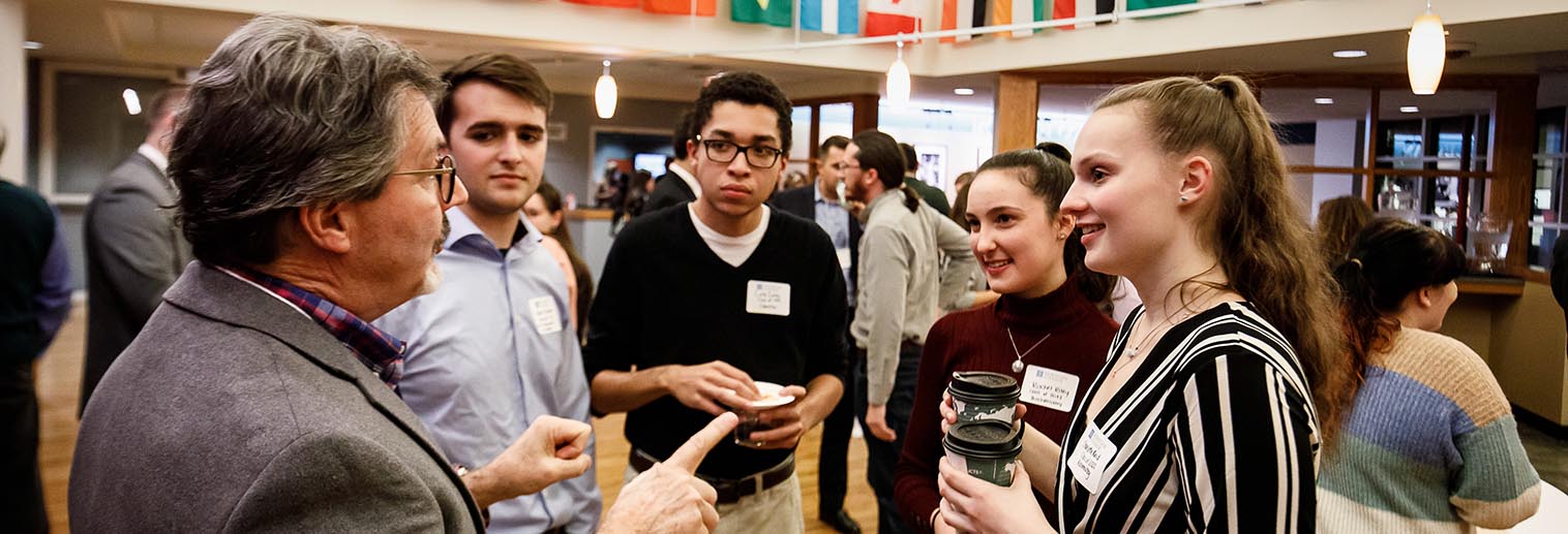 Students networking with alum