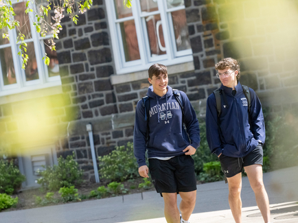Two students walking on campus