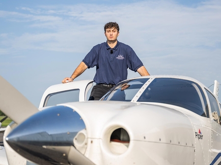 Aviation student in standing in door of plane
