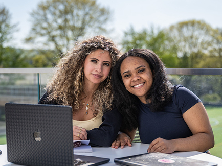Student sitting outside working on laptop