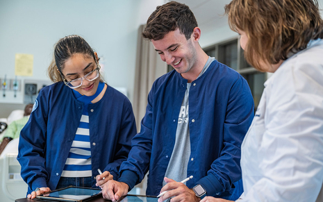Nursing students working on an iPad