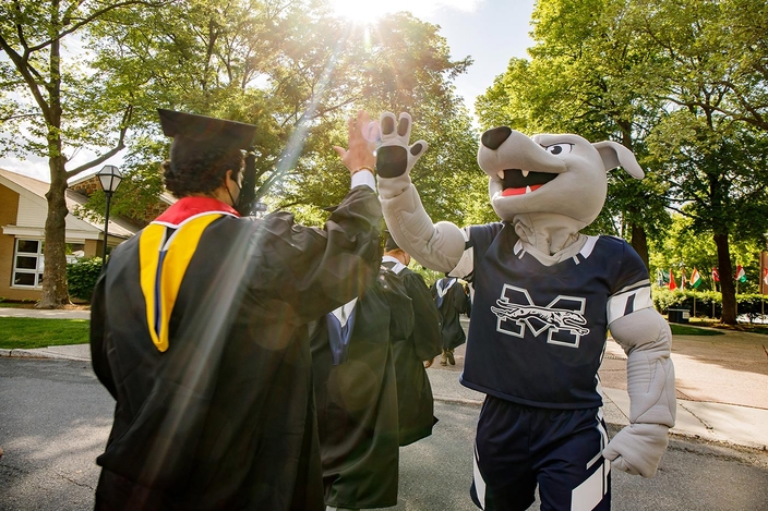 Mascot high fives graduate