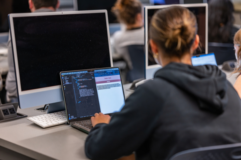 Woman coding on computer