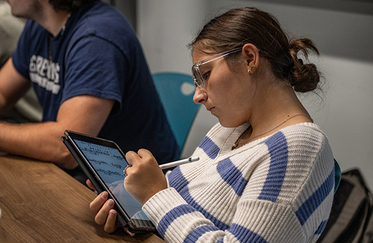 Student in class with iPad