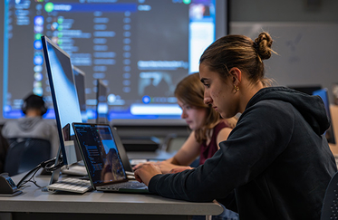 Graphic design student at computer