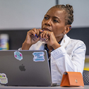 Student sitting in class behind laptop